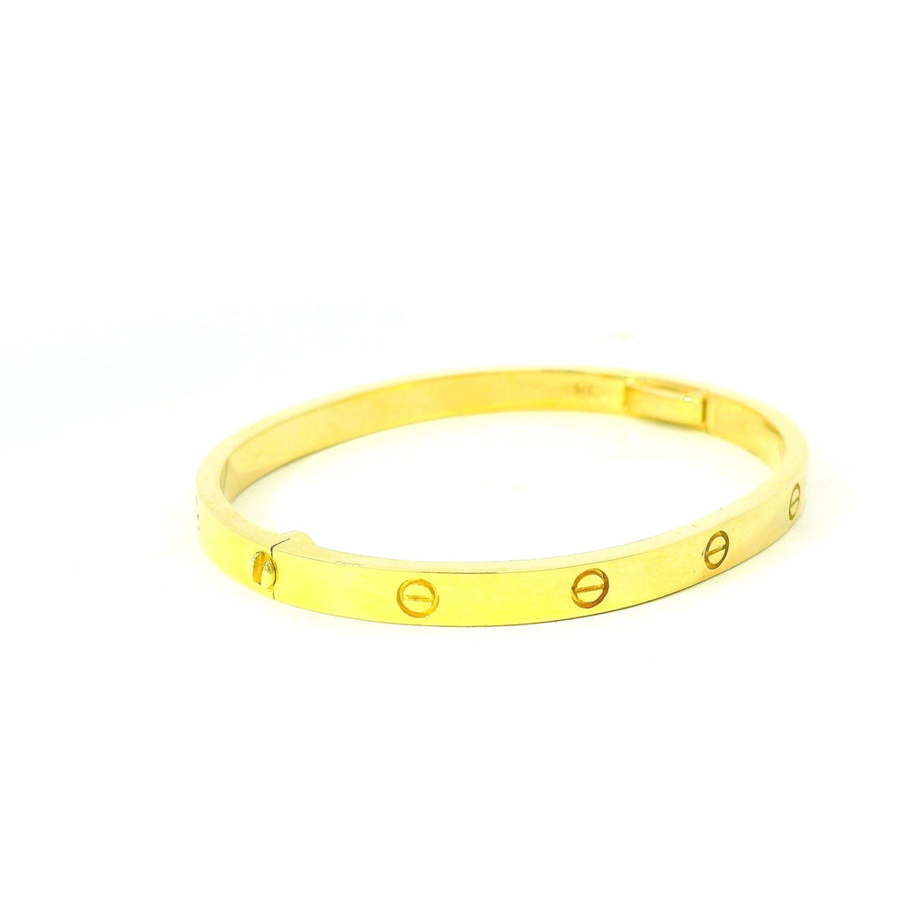 solid gold bangle with circle pattern. screw gold bangle. gold bangle for women