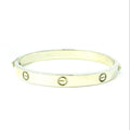 Gold bracelet with circular designs. white gold bracelet with circle design on bangle