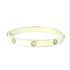Gold bracelet with circular designs. white gold bracelet with circle design on bangle