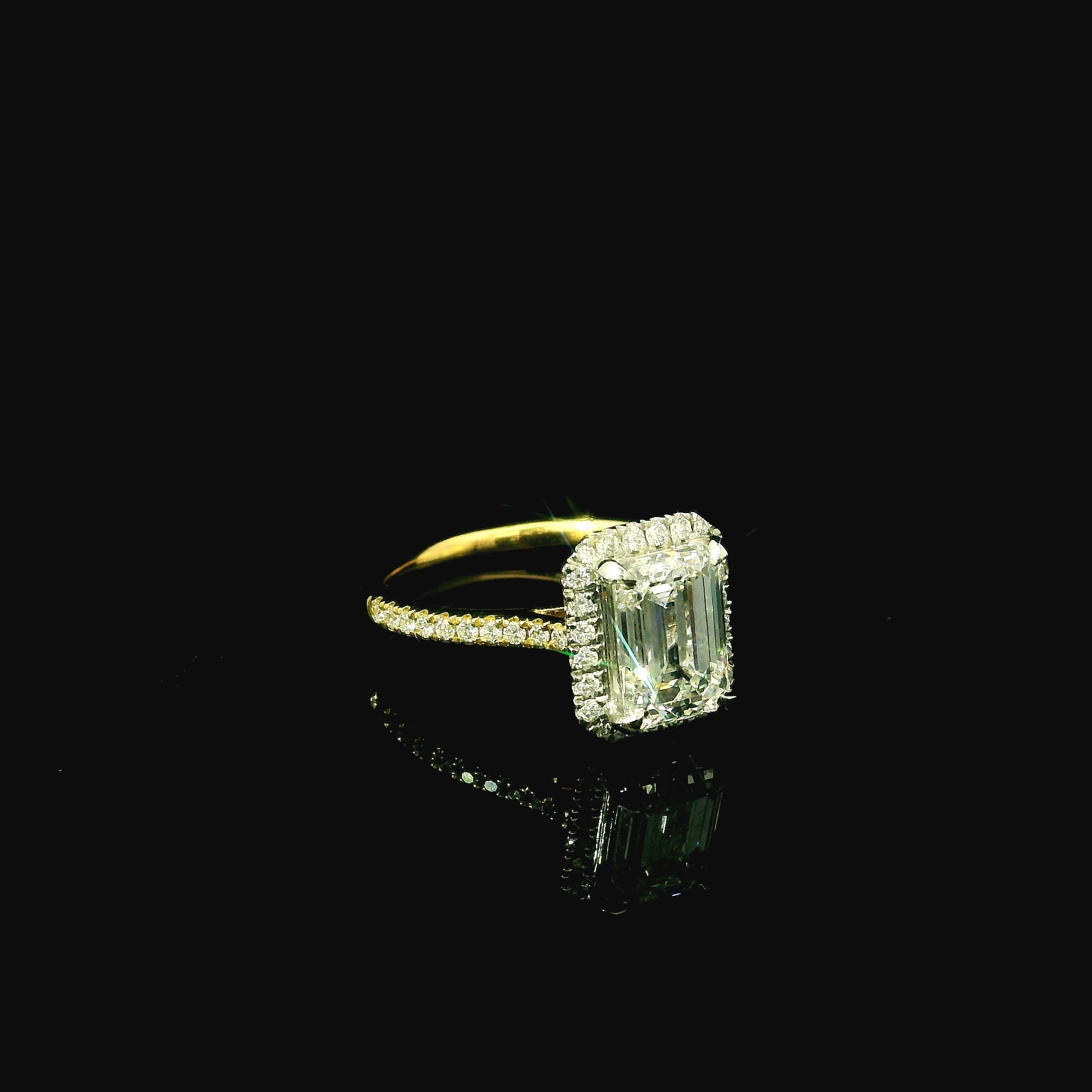 emerald cut diamond. emerald cut diamond rings. square diamond on gold ring. gold ring with emerald cut diamond. diamond ring with diamond halo.