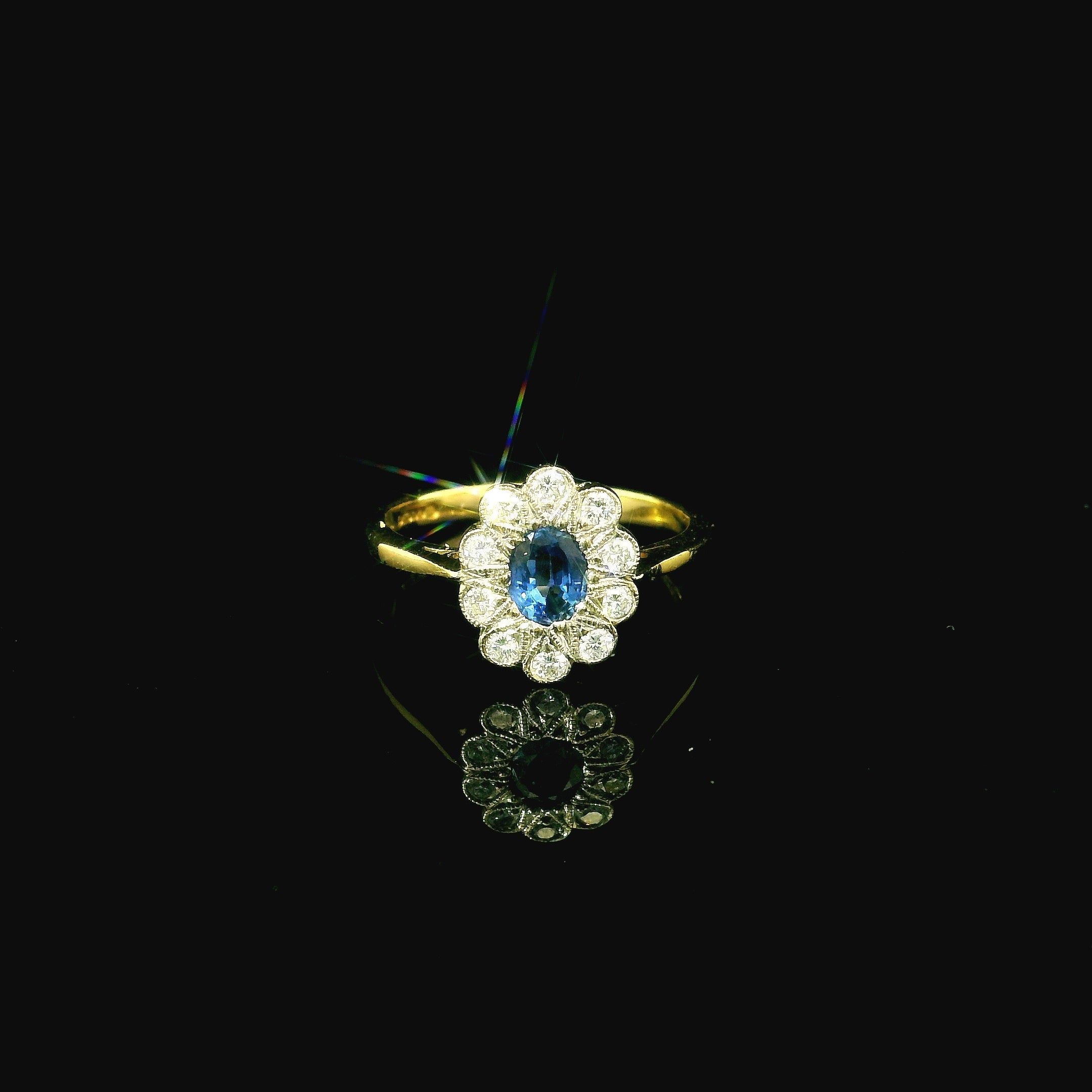 blue sapphire daisy shaped diamond cluster ring. oval cut sapphire