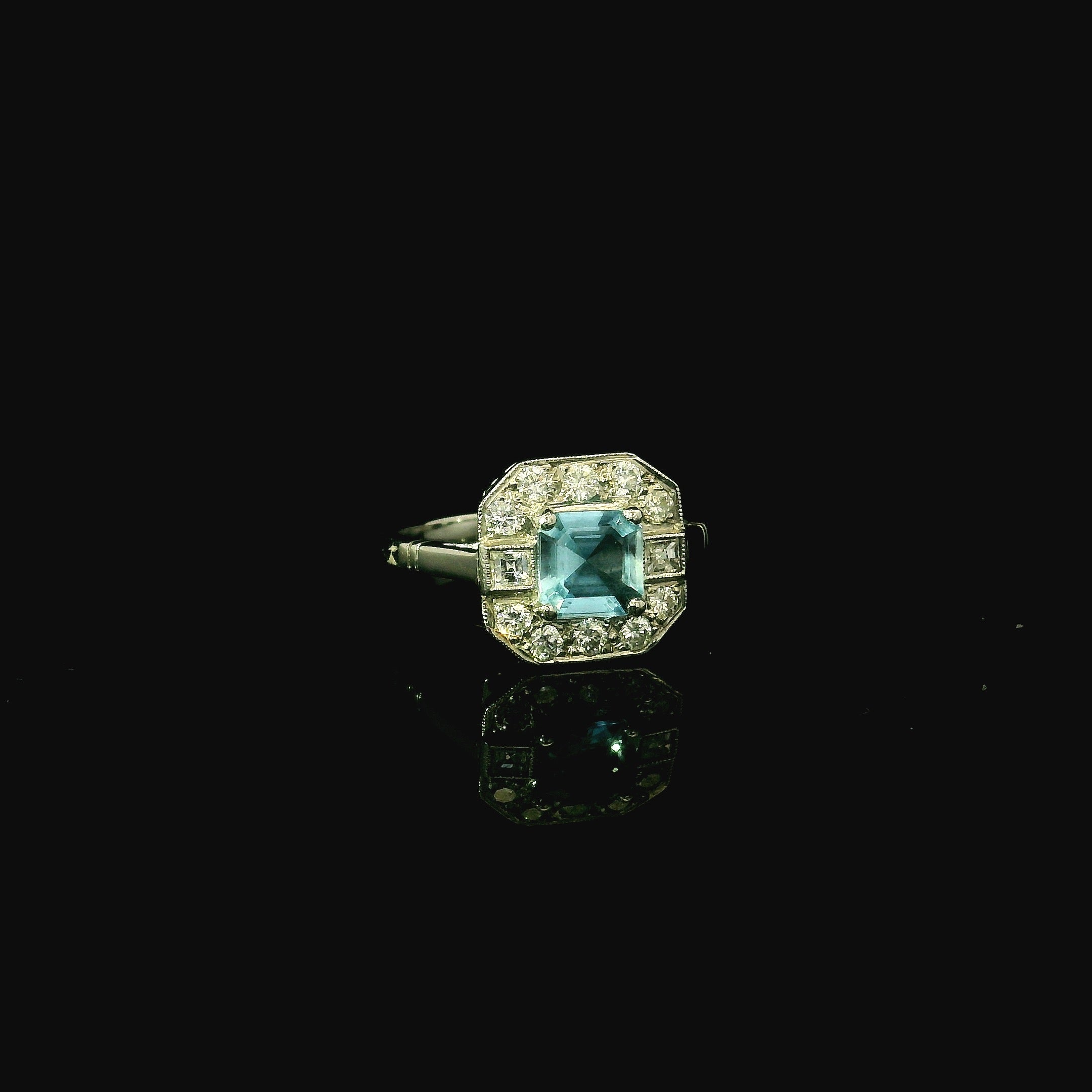 vintage art deco inspired platinum ring with princess cut aquamarine stone
