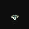 large oval cut aquamarine stone with two surrounding diamonds 