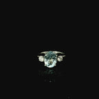 large oval cut aquamarine stone with two surrounding diamonds 