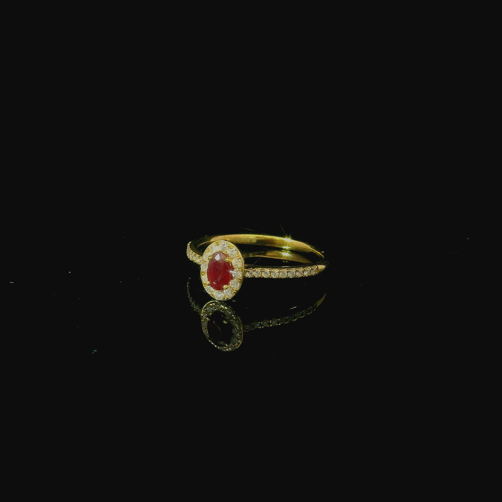 yellow gold ring with an oval cut red ruby gemstone, diamond halo surrounding the ruby. yellow gold ring for sale in kent near me. west malling jewellery. independent jewellery shop in kent. shop local west malling