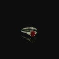 platinum ring with oval cut mid red ruby gemstone. pear cut diamonds 