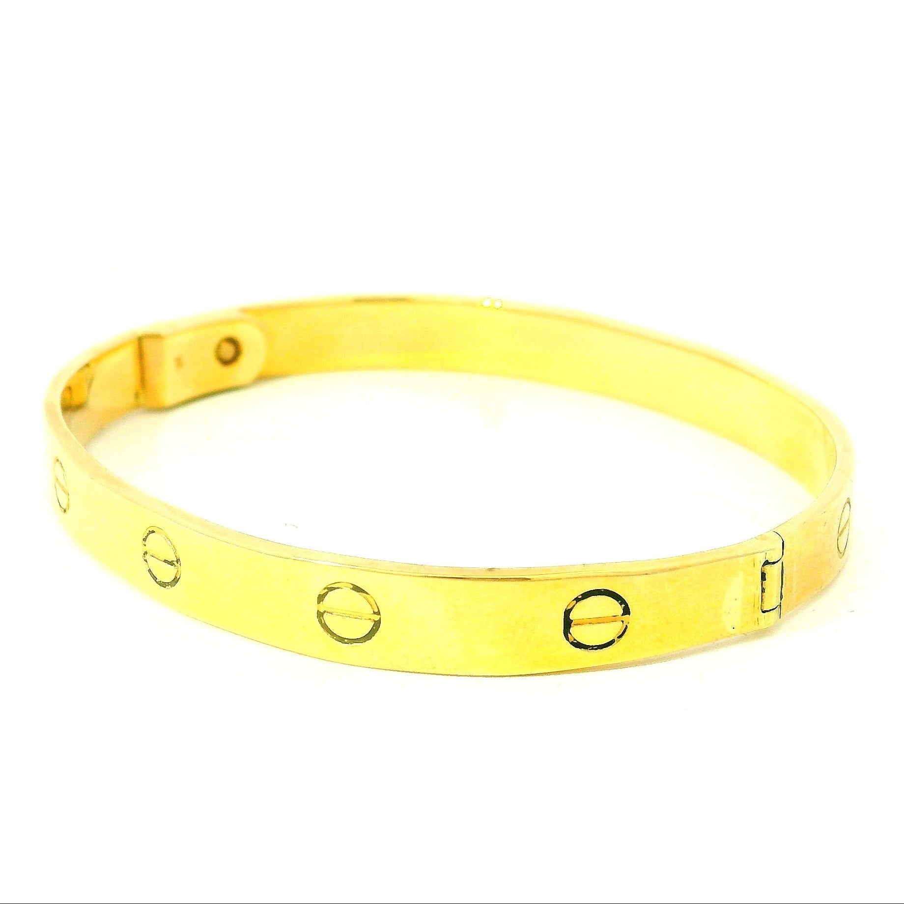 solid gold bangle with screw design. solid gold bracelet with oval marks. christening bracelet gold