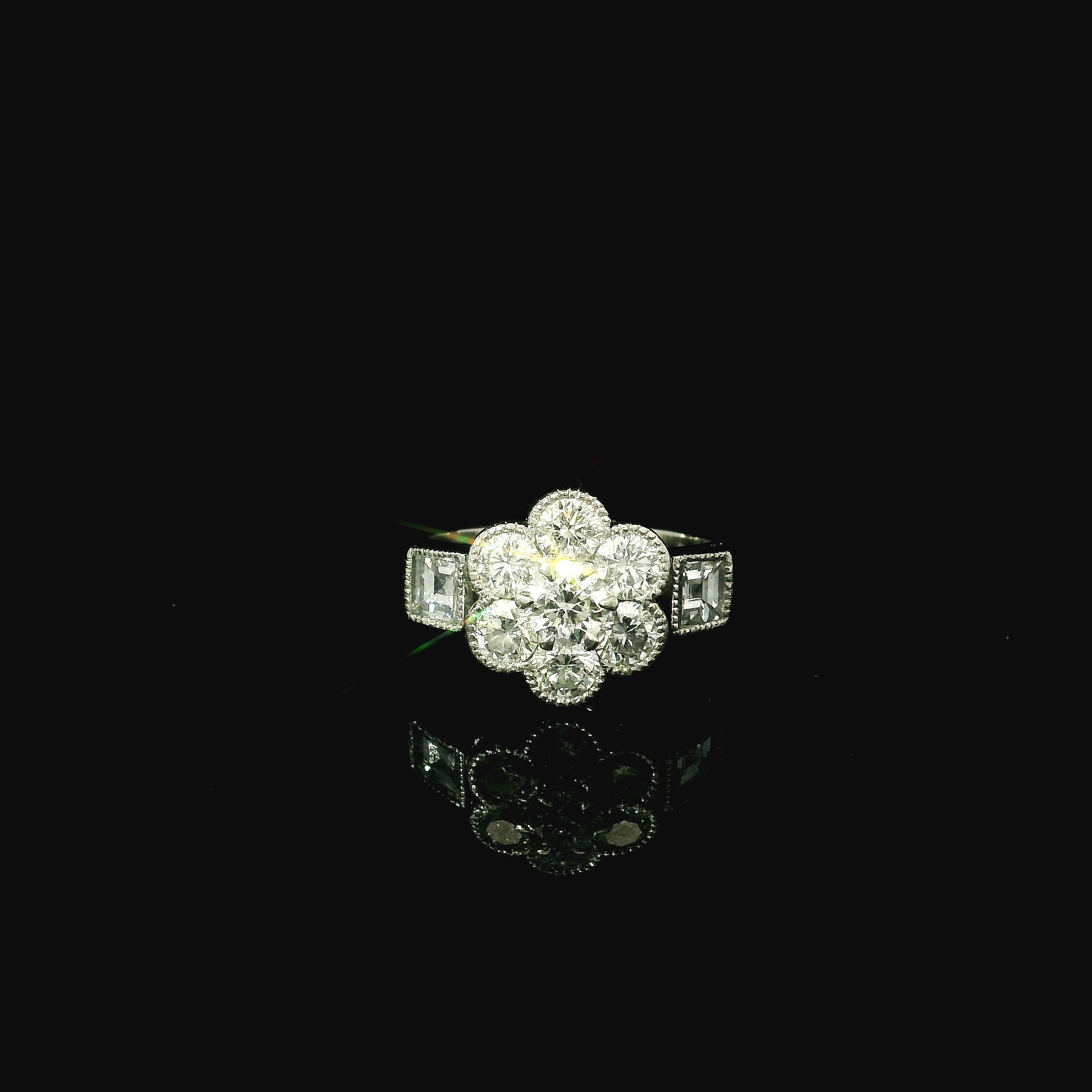 platinum diamond ring. daisy inspired shaped diamond ring. platinum ring with diamond shoulders.