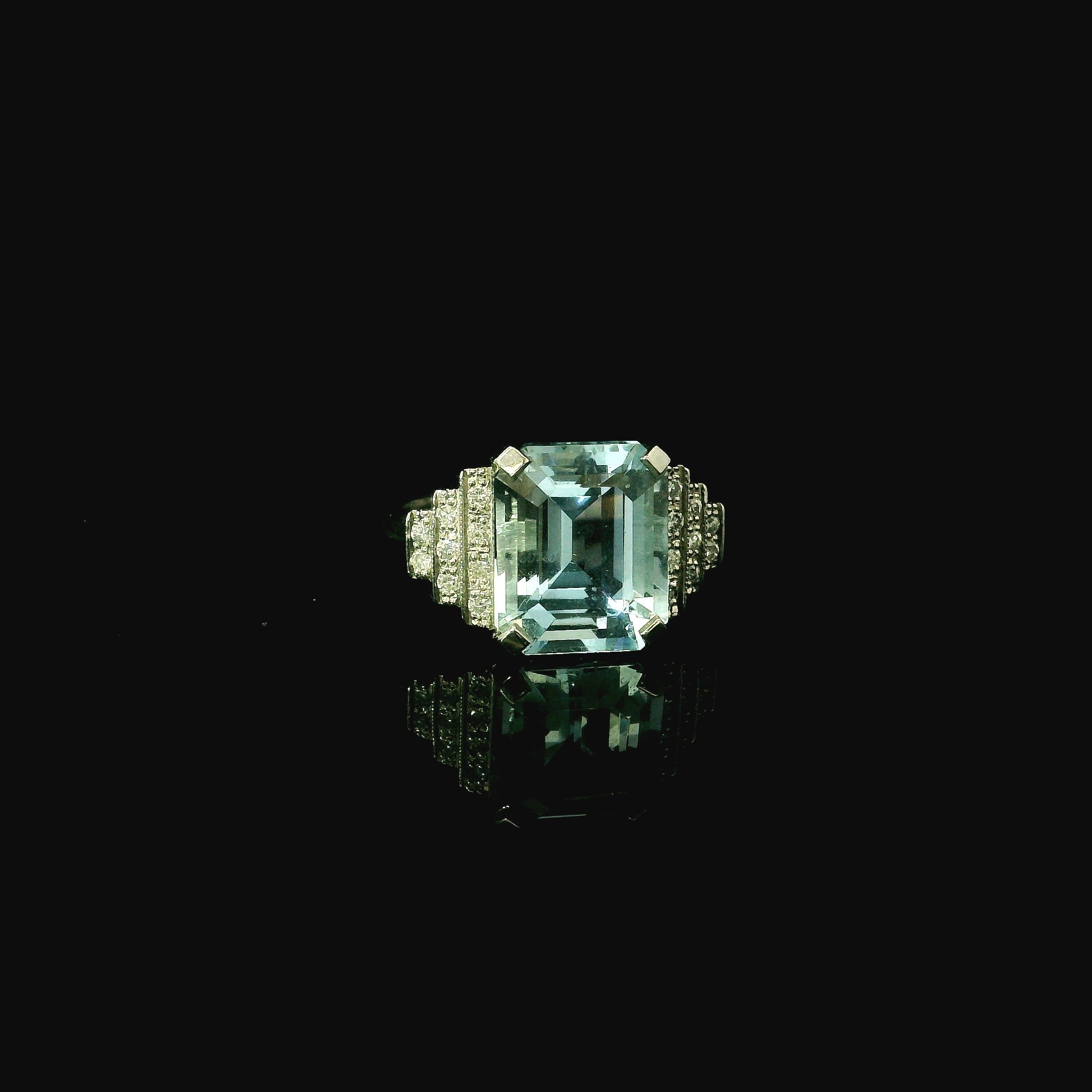 platinum art deco inspired ring with aquamarine stone and diamonds
