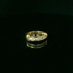 yellow gold ring with embedded diamonds. diamond set in channel 