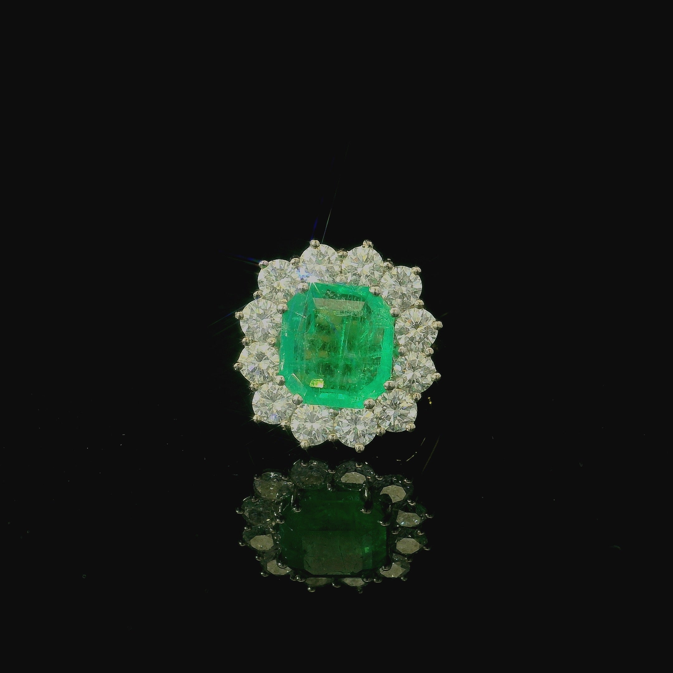 cushion cut solitaire emerald ring. gold ring for women. diamond cluster ring. west malling. jewellers in kent
