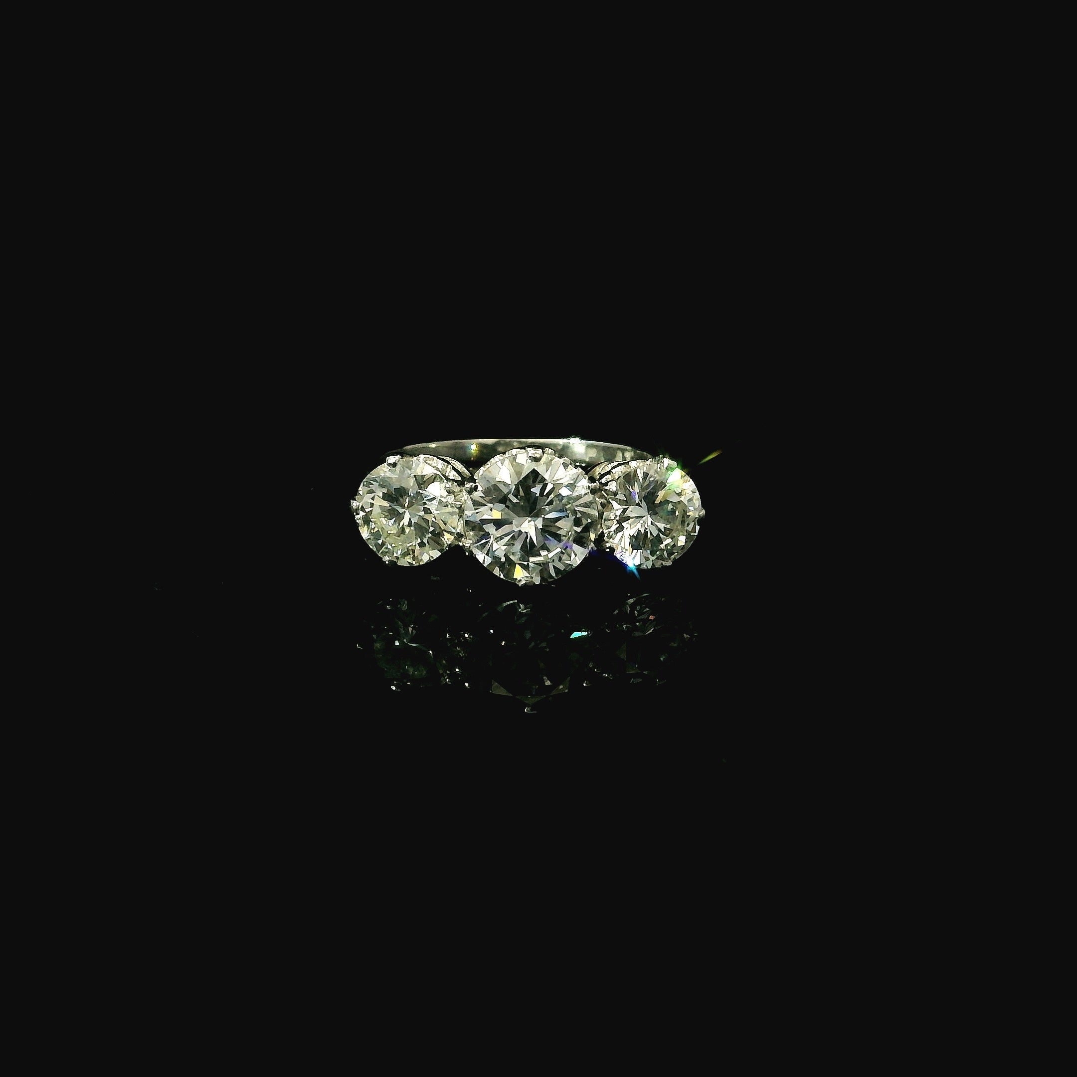luxury 3 diamond ring. platinum preowned ring for women. modern diamond ring.
