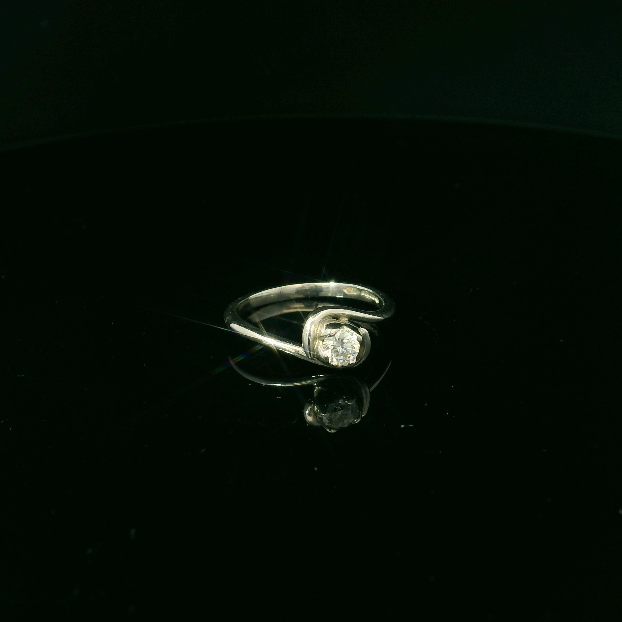 silver ring with twisted mount and diamond solitaire