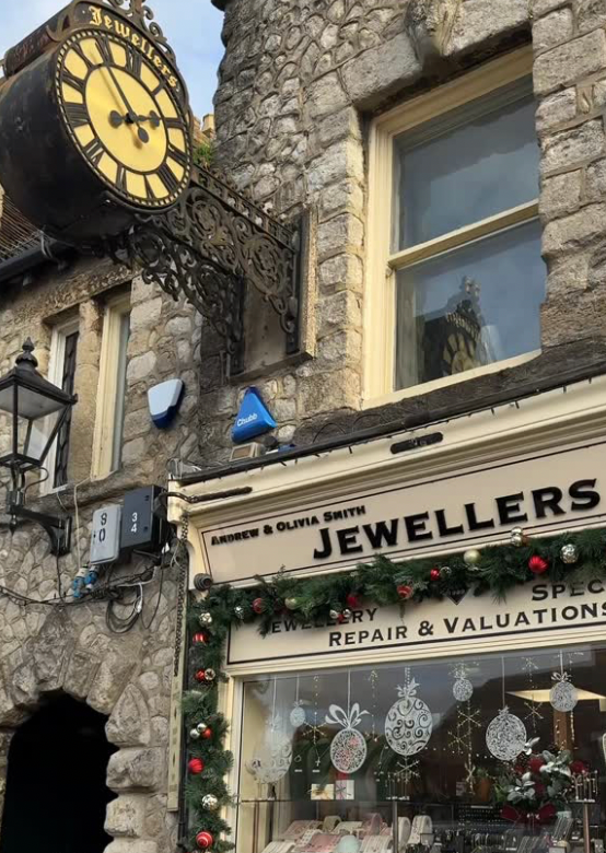 Jewellers shop with a clock on a stone building