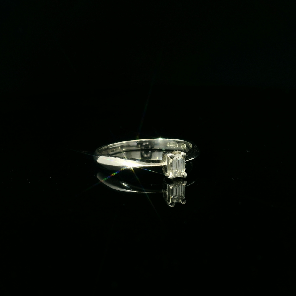 white gold simple ring. emerald cut diamond